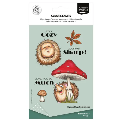 Verpackung des Clear-Stamp-Sets „Hedgy 1" mit einem lächelnden Igel, einem Fliegenpilz und den Sprüchen „Stay Cozy", „Looking Sharp!" und „Love You So Much".