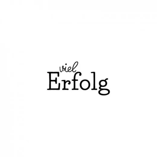 Abdruck des kleinen Holzstempels mit der Aufschrift Viel Erfolg in schwarzer Schrift