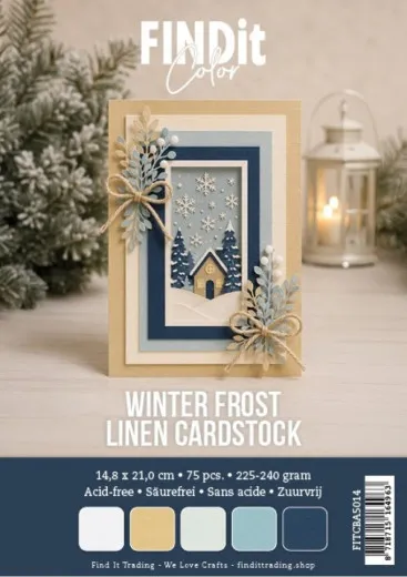 Verpackungsfoto der FIND it Linen Cardstock „Winter Frost” im A5-Format mit Beispielkarte in Blau-Beige-Tönen und Winterhaus-Motiv