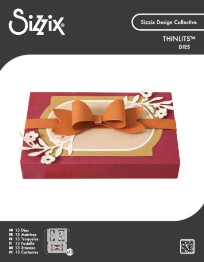 Verpackung der Sizzix Thinlits-Stanzform "Bloom and Bow Box": bordeauxfarbene Box mit gestanzter Schleife und Blütenrahmen.