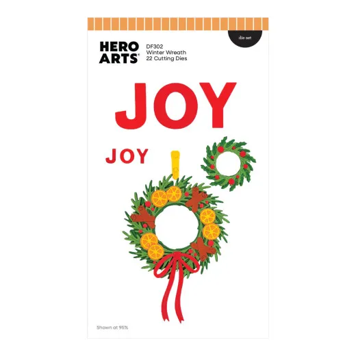 Verpackung des Stanzensets Winterkranz mit koloriertem JOY-Schriftzug und Kranz-Anhänger aus Zweigen, Zitronenscheiben und roter Schleife.