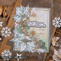 Karte mit weißem Weihnachtsstern, Tannenzweigen, Schneeflocken und Text A Joyous Christmas