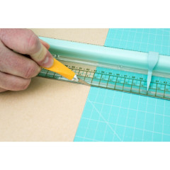 Supreme Ruler Lineal in Anwendung mit gelbem Stift auf Schneidematte, Metallschneidkante sichtbar