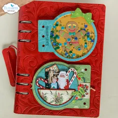 Rotes Ringbuch mit Shaker-Element und Lebkuchenmann sowie Foto mit Weihnachtsmann.