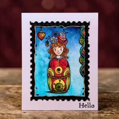 Grußkarte im Briefmarken-Design mit der gestempelten ZOUKI-Poppie-Figur auf blauem Hintergrund und dem Schriftzug „Hello“.