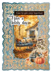 Der gestanzte Rahmen mit eingesetztem Motiv einer Hollywoodschaukel vor einem Herbsthaus sowie den Sprüchen „Time to get cozy together" und „Have a lovely day"