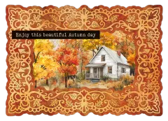 Der gestanzte Rahmen mit eingesetztem Motiv eines weißen Holzhauses im bunten Herbstlaub und dem Spruch „Enjoy this beautiful Autumn day"