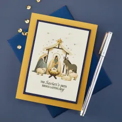 Anwendungsbeispiel: Weihnachtskarte mit Krippenszene in Gold-Blau und dem Spruch 'The Savior's Birth Brings Lasting Joy'.