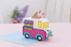Fertig gebasteltes Eiswagen-Modell mit Verkaufsklappe, Blumen-Deko und Eistüte auf dem Dach.