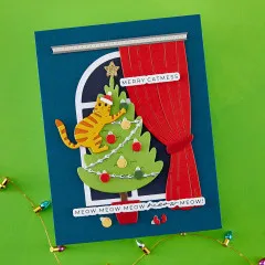 Detailaufnahme der Fensterkarte mit Katze im Weihnachtsbaum und dem Spruch 'Meow Meow Meow Meow Meow!'.
