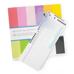 Explosion Board neben buntem Cardstock-Pad in Regenbogenfarben und Falzbein auf weißem Hintergrund