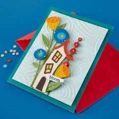 Grußkarte mit Häuschen-Motiv und passendem rotem Umschlag.