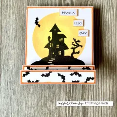 Orangefarbene Steckkarte mit Spukhaus-Silhouette vor Vollmond und den Wortstempeln „Have a", „Eek!" und „Day".
