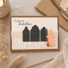 Karte „Liefs van Sinterklaas" mit drei dunklen gestanzten Grachtenhäusern und kupferfarbener Sinterklaas-Silhouette auf Jute-Band.