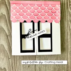 Karte in Hausform mit Dach aus rosa geprägten Schuppen und Schild Nieuwe adres