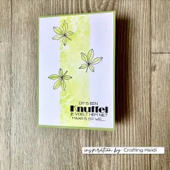 Karte „Dit is een Knuffel" mit drei gestempelten Blättern auf gelb-grünem Aquarellstreifen.