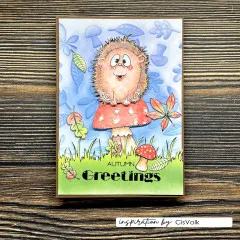 Karte „Autumn Greetings" mit Igel auf einem Fliegenpilz vor geprägtem Blätter-Hintergrund in Blautönen.