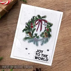 Weiße Karte mit gestempeltem Kranz mit Schleife und Text Joy to the world