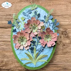 Ovale Karte mit pfirsich-korallenfarbenen Zinnien-Blüten, grau-blauen Blättern und grünem Rahmen.