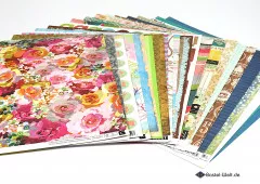 Scrapbook Paper Pad 25 Bögen gestapelt, zeigt Vielfalt der Designs, Farben und Muster von oben