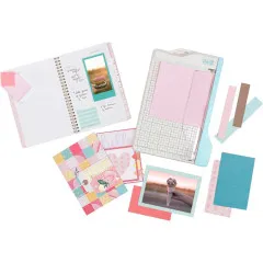 Mini Guillotine Paper Cutter mit verschiedenen ausgeschnittenen Papierstücken in Rosa, Beige und Türkis