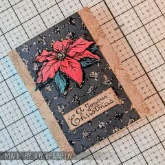 Karte mit rotem Weihnachtsstern auf Schwarz und Etikett A Joyous Christmas