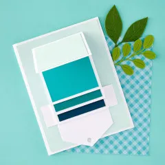 Fertig gestaltete Spellbinders Waterfall Karte mit Grüntönen und Blättern auf blauem Hintergrund