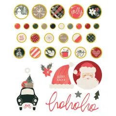 Alle 27 Metall-Brads und 7 Chipboard-Teile der Kollektion Mistletoe & Holly einzeln aufgereiht, darunter Weihnachtsmann-Kopf und Auto mit Baum