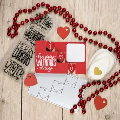 Valentinstagskarte mit roter Perlenkette und Herzmotiven auf Holzoberfläche arrangiert.