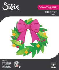 Farbiger Stanzformen-Kranz aus grünen Zweigen mit pinker Schleife, goldenen Rauten, Beeren und Sternen