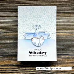 Weihnachtskarte mit Schneeflocken-Prägung, gestempeltem Wal und Text Have a Whaley Merry Christmas